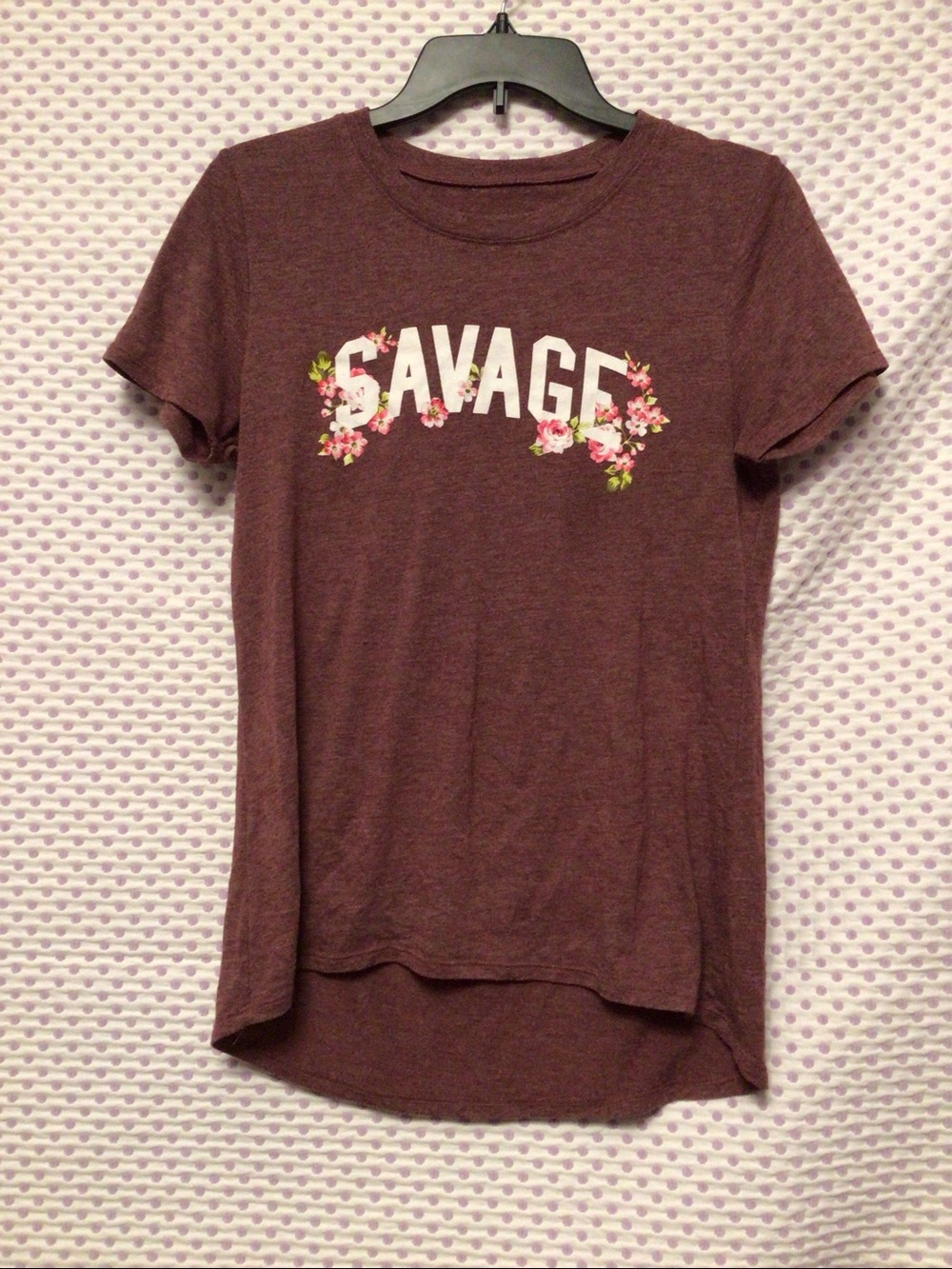 short sleeve tee with a white "Savage" graphic surrounded by floral details